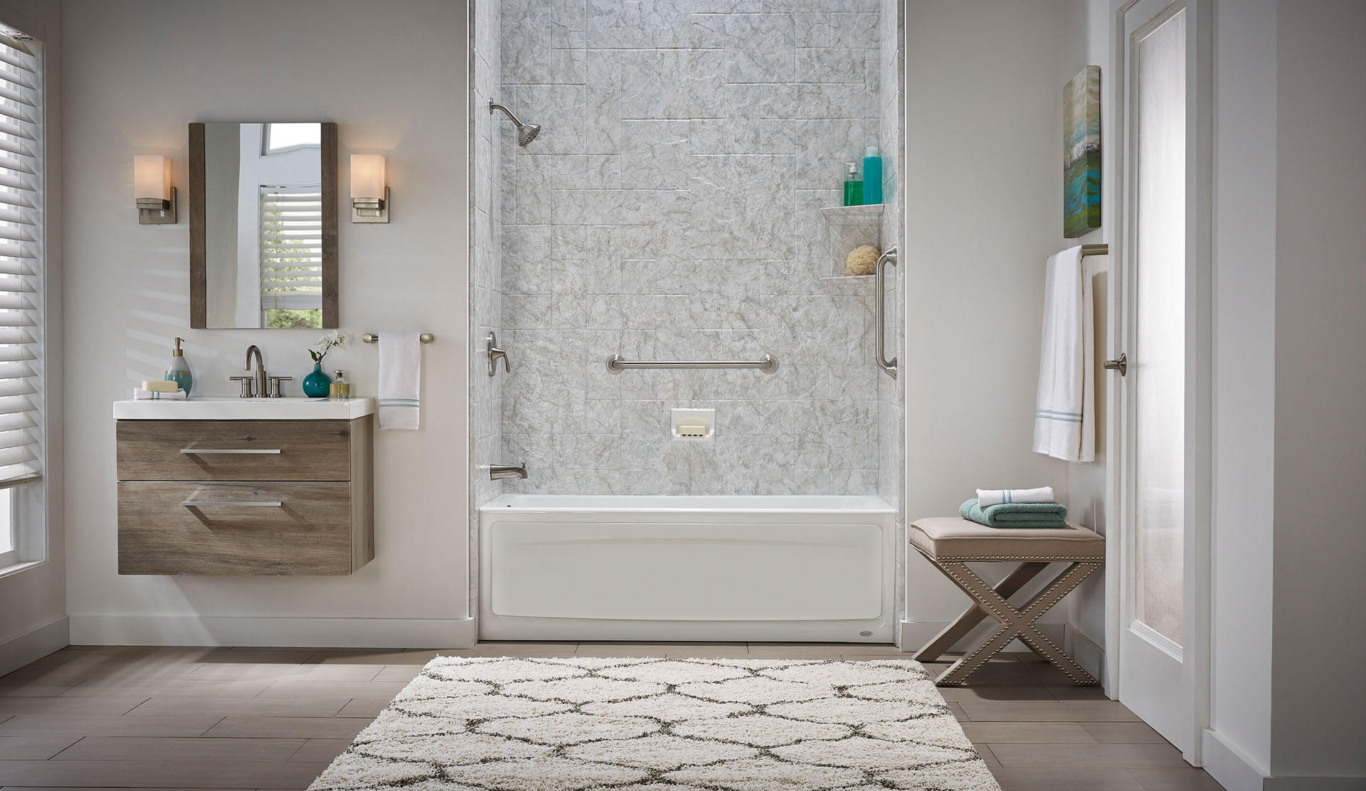 A beautiful bathroom has a bathtub and shower combination with gray textured tile walls.