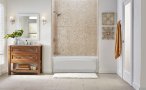 A modern bathroom has beige tile floors a tub and shower combo and a sleek wood vanity. 