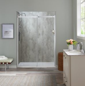 A modern walk in shower with glass doors and a silver frame.