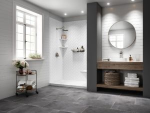 A modern bathroom has a step-in shower with white herringbone tile walls.