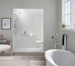 A luxurious bathroom has a freestanding tub and a walk-in shower with white walls and a shower seat.