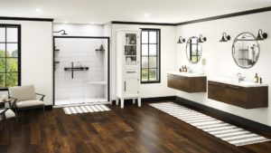 A very large bathroom has two wood floating vanities and a walk-in shower.