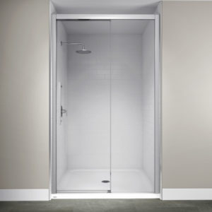 A sleek walk-in shower with a glass door and white subway tile.