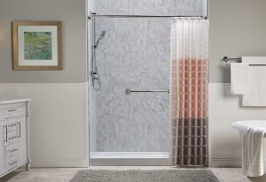 A Bathroom with gray tiles and shower curtains.